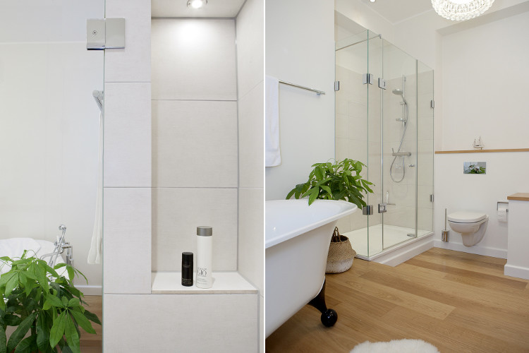 Wohnungsmodernisierung Wandnische Duschtasse mit Duschtrennwand aus Glas und wandhängendes WC und Ablagen aus Holz in Düsseldorf-Zooviertel