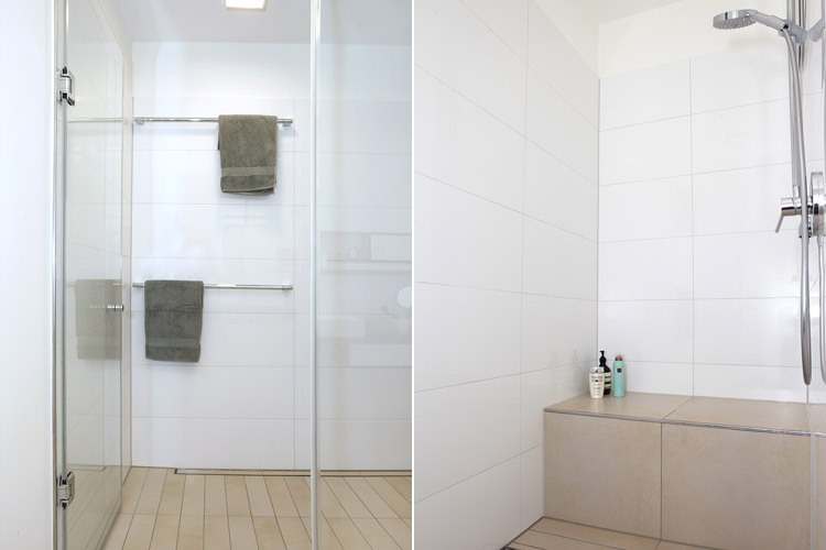 Badezimmer mit bodenbündiger Dusche mit Sitzbank und Bodenablaufrinne mit hellen Bodenfliesen und Wandfliesen in Düsseldorf-Oberkassel